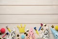 Flat lay composition with party hats and other festive items on white wooden background. Space for text Royalty Free Stock Photo