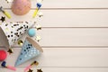 Flat lay composition with party hats and other festive items on white wooden background. Space for text Royalty Free Stock Photo