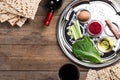 Flat lay composition with Passover Seder plate keara on wooden table. Pesah celebration Royalty Free Stock Photo