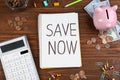 Flat lay composition with phrase SAVE NOW written in notebook on wood Royalty Free Stock Photo