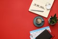 Flat lay composition with phrase Travel Tips written in notebook, passports, tickets and cup of coffee on red background. Space Royalty Free Stock Photo