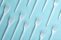 Flat lay composition with plastic forks on color background. Royalty Free Stock Photo