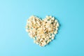 Flat lay composition with popcorn heart on blue background Royalty Free Stock Photo