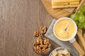 Flat lay composition with pot of tasty cheese fondue on wooden table Royalty Free Stock Photo