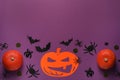 Flat lay composition with pumpkins, paper bats and spiders on purple background, space for text. Halloween celebration Royalty Free Stock Photo