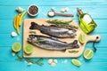 Flat lay composition with raw cutthroat trout fish on blue wooden table Royalty Free Stock Photo