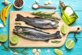 Flat lay composition with raw cutthroat trout fish on blue wooden table Royalty Free Stock Photo