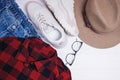 Flat lay composition with red chekered shirt, hat and sneakers. Royalty Free Stock Photo