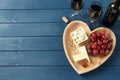 Flat lay composition with red wine and snacks on blue wooden table, space for text Royalty Free Stock Photo