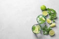 Flat lay composition with refreshing lime beverage and ingredients on light background Royalty Free Stock Photo