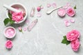Flat lay composition with rose essential oil and fresh flowers on grey table Royalty Free Stock Photo