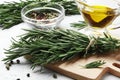 Flat lay composition with rosemary, spices, oil on white concrete backgroun Royalty Free Stock Photo