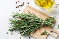 Flat lay composition with rosemary, spices, oil on white concrete background, Royalty Free Stock Photo