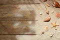 Flat lay composition with seashells, beach sand and space for text on wooden Royalty Free Stock Photo