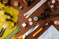 Flat lay composition of sewing accessories, scissors, patterns, fabrics on a brown background, top view. The desktop of a fashion Royalty Free Stock Photo
