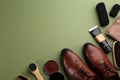 Flat lay composition with shoe care accessories and footwear on green background. Space for text