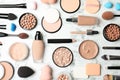 Flat lay composition with skin foundation, powder and beauty accessories