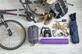 Flat lay composition with sleeping bag, bicycle and camping equipment