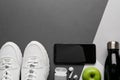 Flat lay composition with smartphone and sport equipment on color background. Space for text Royalty Free Stock Photo