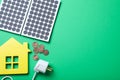 Flat lay composition with solar panels, house model and coins on background. Space for text Royalty Free Stock Photo