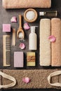 Flat lay composition of some bath accessories on a dark brown rustic background. View from above Royalty Free Stock Photo