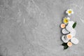 Flat lay composition with spa stones, flowers and candles on grey marble background Royalty Free Stock Photo