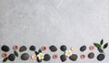 Flat lay composition with spa stones and lit candles on grey marble background, space Royalty Free Stock Photo