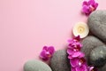 Flat lay composition with spa stones and orchid flowers on pink background Royalty Free Stock Photo