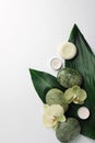 Flat lay composition with spa stones, solid shampoo bar and beautiful flowers on white table. Space for text Royalty Free Stock Photo