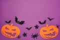 Flat lay composition with spooky paper pumpkins, spiders and bats on purple background, space for text. Halloween celebration Royalty Free Stock Photo