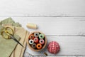 Flat lay composition with spools of threads and sewing tools on white wooden table, space for text Royalty Free Stock Photo