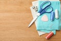 Flat lay composition with spools of threads and sewing tools on wooden table. Space for text Royalty Free Stock Photo