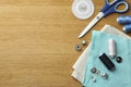 Flat lay composition with spools of threads and sewing tools on wooden table. Space for text Royalty Free Stock Photo