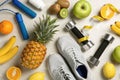 Flat lay composition with sport items and healthy food on grey background.