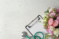 Flat lay composition with stethoscope and flowers on  wooden background, space for text. World health day Royalty Free Stock Photo