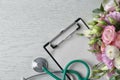 Flat lay composition with stethoscope and flowers on white wooden background. World health day Royalty Free Stock Photo