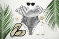 Flat lay composition with striped swimsuit and beach accessories on light stone Royalty Free Stock Photo