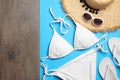 Flat lay composition with stylish beach accessories on blue paper and wooden background, space Royalty Free Stock Photo