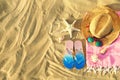 Flat lay composition with stylish beach accessories on sand Royalty Free Stock Photo