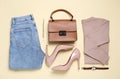 Flat lay composition with stylish clothes, shoes and accessories on beige background Royalty Free Stock Photo