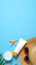 Flat lay composition with sunscreen and beach accessories on light blue background Royalty Free Stock Photo