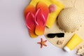 Flat lay composition with sunscreen and beach accessories on white background, space for text Royalty Free Stock Photo