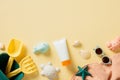 Flat lay composition with sunscreen cream in tube, children\'s beach toys, sunglasses, seashells, towel Royalty Free Stock Photo