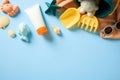 Flat lay composition with sunscreen tube and vibrant collection of beach essentials on light blue background Royalty Free Stock Photo