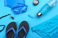 Flat lay composition with swimming accessories on background