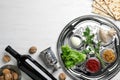 Flat lay composition with symbolic Passover Pesach items and meal on wooden background