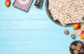 Flat lay composition with symbolic Pesach Passover Seder items on light blue wooden table, space for text Royalty Free Stock Photo