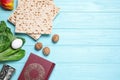 Flat lay composition with symbolic Pesach Passover Seder items on blue wooden table, space for text Royalty Free Stock Photo