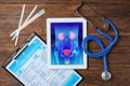 Flat lay composition with tablet, stethoscope