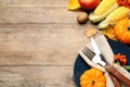 Flat lay composition with tableware, autumn fruits and vegetables on wooden background, space for text. Thanksgiving Day Royalty Free Stock Photo